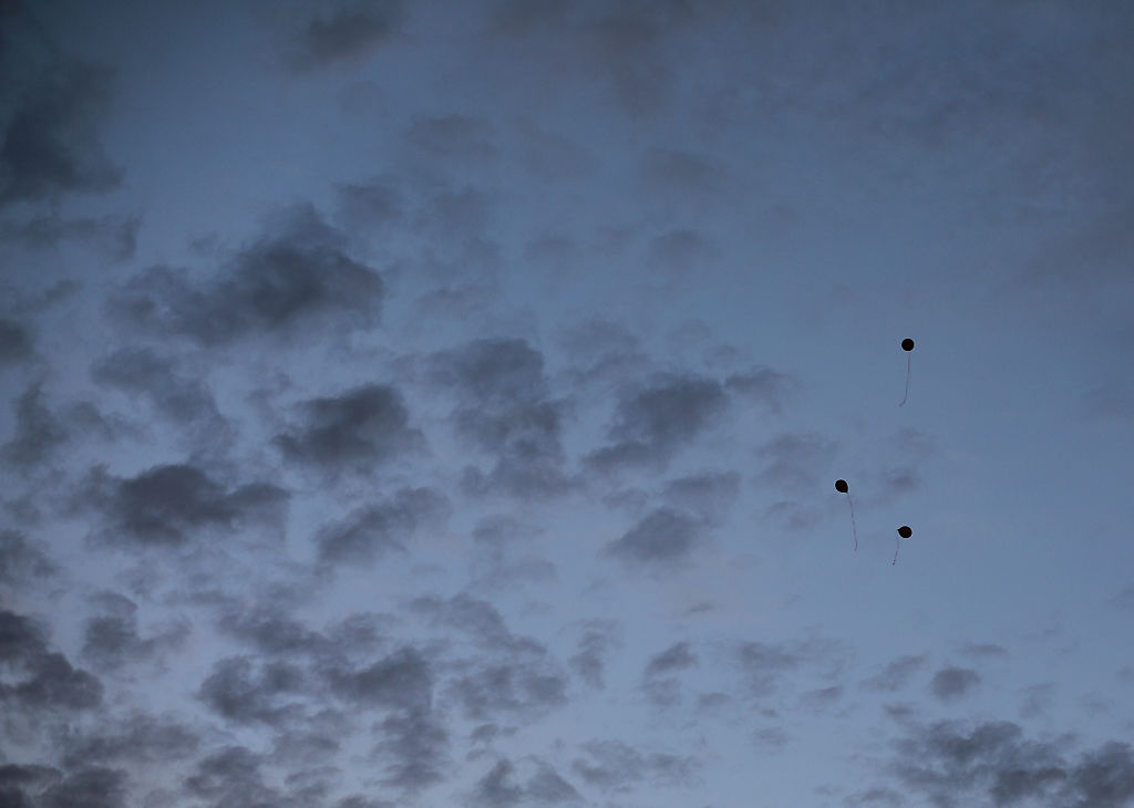 Three balloons float above the field during Rock Bridge's homecoming game